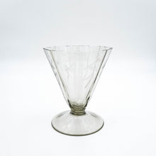 Carica l'immagine nel visualizzatore di Gallery, Servizio di bicchieri anni 30 in vetro fumè di forma ottagonale completo per sei persone, composto da cinque bicchieri per ogni posto tavola e due bottiglie per il vino. Particolare del bicchiere da acqua. - Complete set of 1930s octagonal smoked glass glasses for six people, consisting of five glasses for each table setting and two bottles for wine. Detail of the water glass.